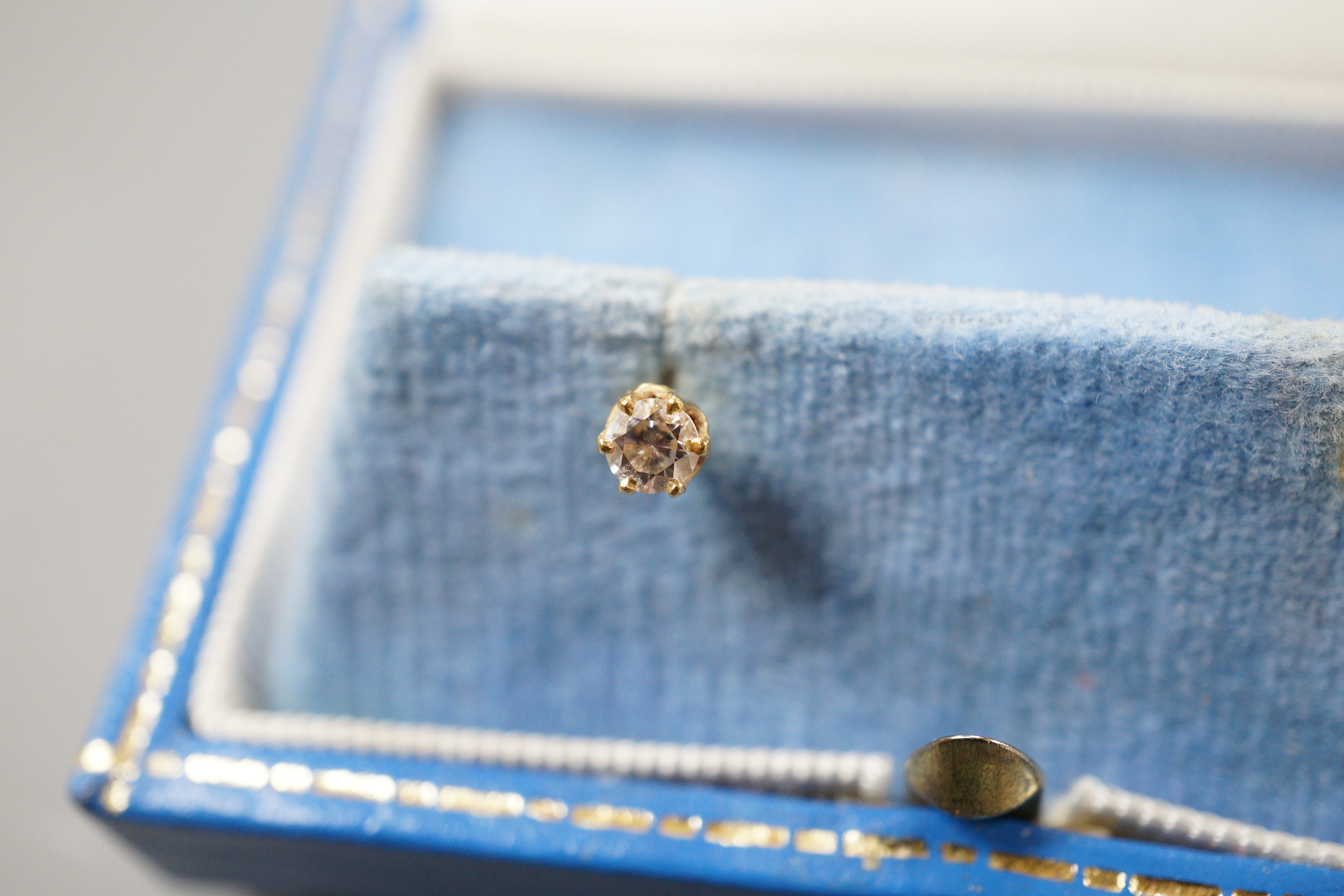 A pair of 750 yellow metal and solitaire diamond set ear studs, gross weight 0.9 grams